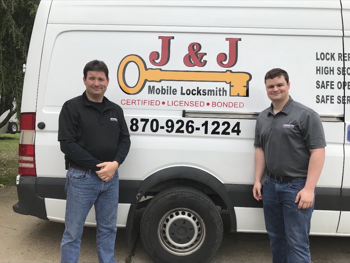 The two J & J Mobile Locksmith technicians standing in front of their work van