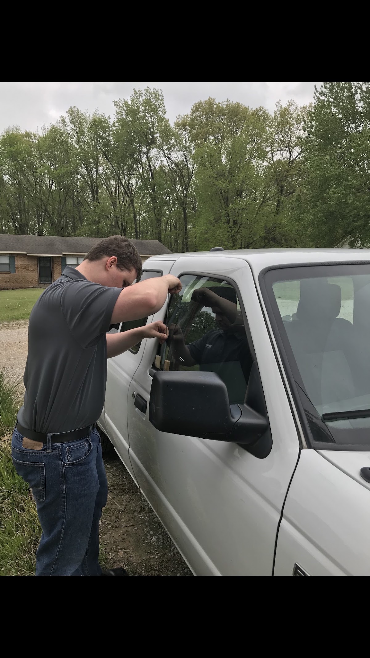 A J & J locksmith opening the door of a pickup truck